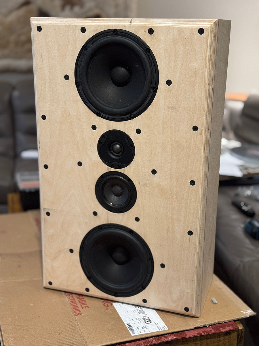 A custom-built multi-driver loudspeaker with a raw plywood baffle